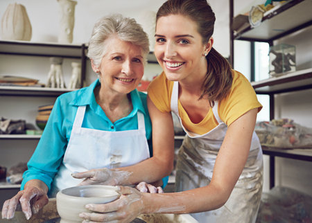 Time to play with clay. a senior woman making a ceramic pot at a pottery class.の写真素材