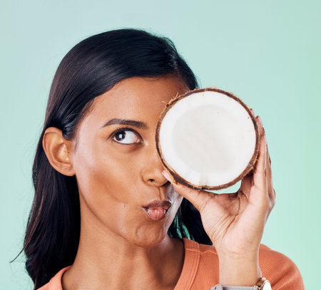 Beauty, face or wellness woman with coconut for natural skincare glow, organic cosmetics or eco...