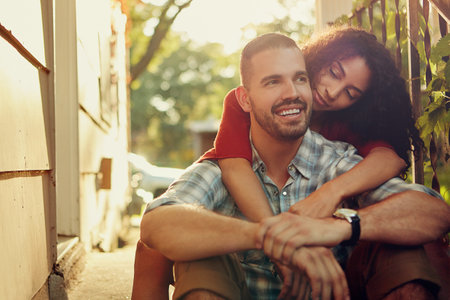Life with him makes perfect sense. a young woman embracing her boyfriend from behind.の写真素材