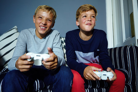 Its all fun and games. young boys playing video games.