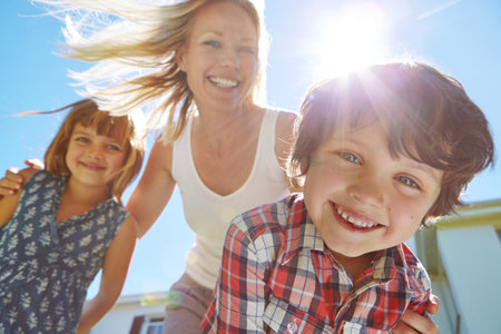 Whos ready for some summer fun. a happy family of three enjoying a sunny day in their backyard.の写真素材