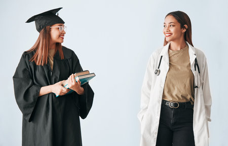 Graduation, medicine and medical student with degree, certificate and diploma achievement isolated in a studio white background. Scholarship, future and happy woman graduate or certified doctorの写真素材
