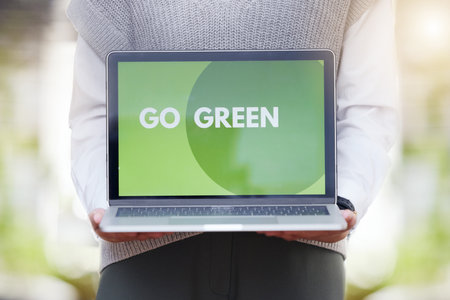 Person, screen or laptop of go green, sustainability or eco friendly conservation website for planet earth. Recycle, technology or global message for carbon footprint, clean energy and climate changeの写真素材