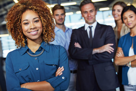 We make an excellent team. Portrait of a team of professionals standing together in an office.