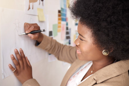 Fashion, business and black woman writing, planning and ideas for designs, prepare for show and creativity. Female employee, designer and creative with pen, brainstorming, new project and startupの写真素材