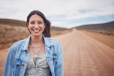 Woman, portrait smile and countryside travel for holiday break, vacation or road adventure journey in the outdoors. Happy female traveler smiling for fun traveling in joy for outing in dessert safariの写真素材