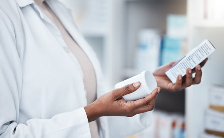 Hands, pharmacy and choice with box, medicine and decision with prescription for healthcare. Pharmacist, black woman and pharmaceutical pills for health, wellness or medical store with stock on shelfの写真素材