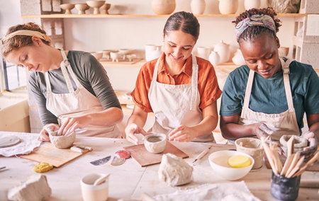 Pottery class, creative workshop or women design sculpture mold, clay manufacturing or art product. Diversity, ceramic retail store or startup small business owner, artist or studio group moldingの写真素材