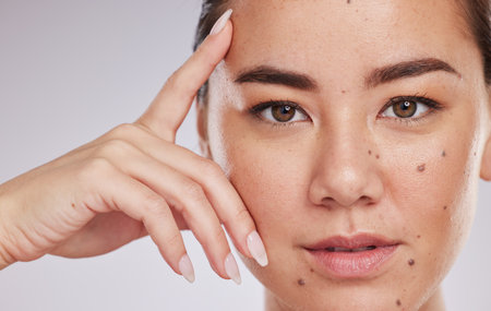 Face portrait, skincare and beauty of woman in studio isolated on a gray background. Makeup, natural cosmetics and young female model with glowing, healthy or flawless skin after spa facial treatmentの写真素材