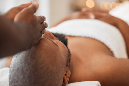 Spa, African man and masseuse hands for head massage, mental health and body wellbeing. Calm, relax and luxury beauty skincare wellness, physical therapy treatment or peaceful facial skin detoxの写真素材