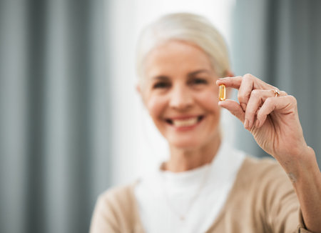 Pill, medicine and portrait of senior woman for pharmaceutical, medical product and retirement health. Happy elderly person hand holding tablet or supplement for healthy life and vitamins healthcareの写真素材