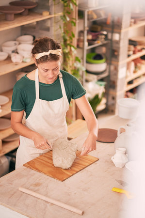 Pottery, creative and small business with a woman designer working in her studio for art from above....