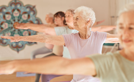 Yoga fitness, class and senior women training for elderly wellness, health and retirement self care in pilates studio. Healthcare, body workout and calm group of people exercise for healthy lifestyleの写真素材