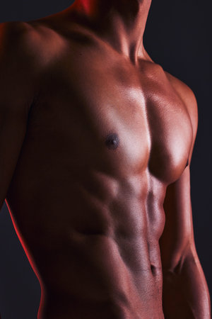 Beauty, closeup and abs of man in studio for fitness, muscle and bodybuilder. Natural, workout and...