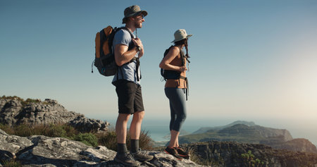 Whatever the question hiking is the answer. a man and woman hiking up a mountain.の写真素材