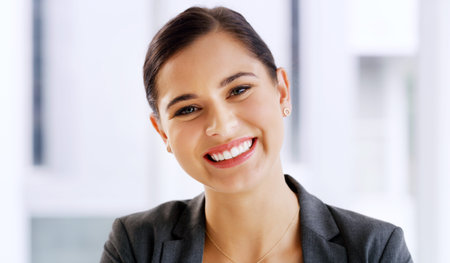 Success has her smiling from ear to ear. Portrait of an attractive young businesswoman smiling and...
