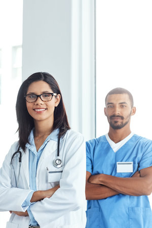 Twice the medical expertise. Portrait of two confident young doctors working in a modern hospital.