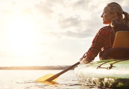 I have total freedom. an attractive young woman out for canoe ride on the lake.の写真素材