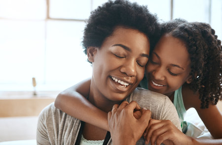 The strongest bond ever created between mother and daughter. a mother and daughter at home.の写真素材