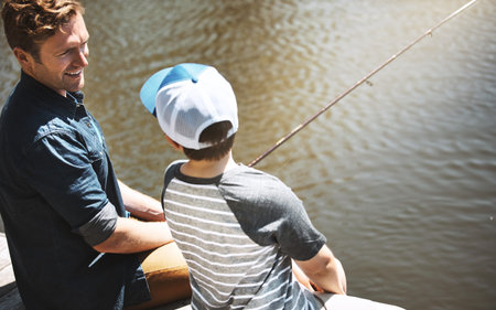 We cast and then we wait...Rear view shot of a father and his little son fishing together.