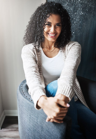 What will she do today. Portrait of a cheerful young woman relaxing while being seated on a chair at...