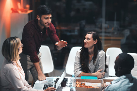 Next level dedication. colleagues having a meeting during a late night in a modern office.の写真素材