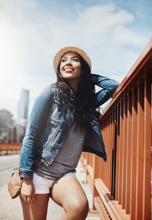 Curious on a summers day. a beautiful young woman out exploring the city.の写真素材