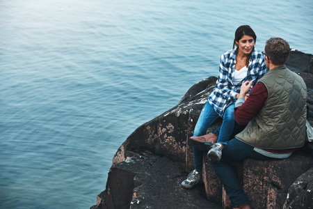 We should do this more often. a loving couple taking a break while out exploring nature.の写真素材
