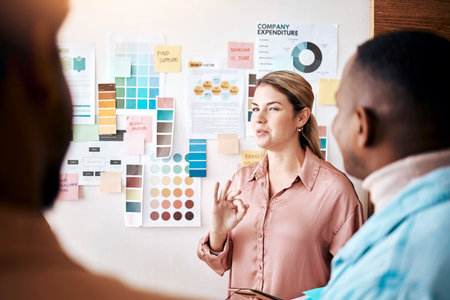 Planning, teamwork and presentation with a business woman talking to her team in the company office....