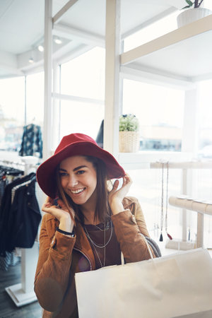 What could be better than a shopping spree. Cropped portrait of an attractive young woman out on a shopping spree.の写真素材