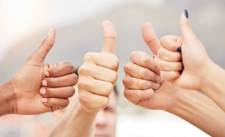 Closeup of people, hands and thumbs up for teamwork, collaboration and agreement of solidarity...