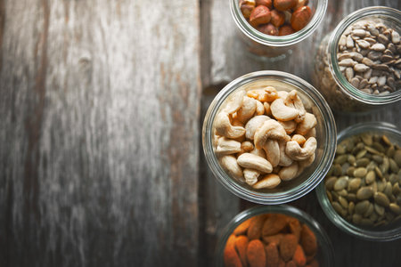 Great for an energy boost. High angle shot of bowls of various nuts on a table.の写真素材