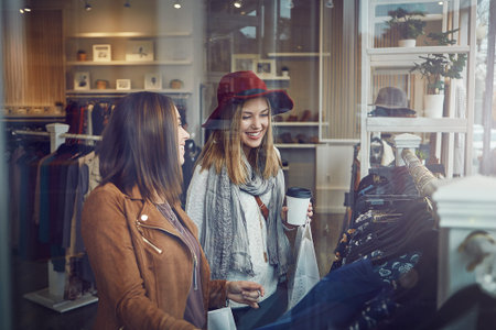 Do you think itll look good on me. two best friends out shopping in a clothing store.