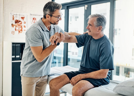 Youre mobility just keeps improving. a skilled physiotherapist testing his mature patients mobility in the rehabilitation center.の写真素材