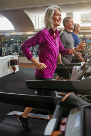 Getting into shape for life. a group of mature people exercising on treadmills at the gym.