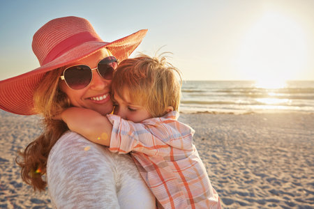 Nothing better than hugs from my little guy. a happy mother and son in a warm embrace at the beach.の写真素材