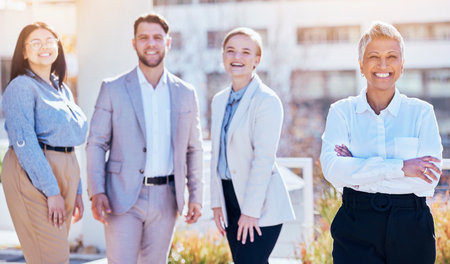 Portrait, group of happy business people at team building outside modern office and employees at creative start up. Diversity, happiness and smile, man and women with proud work leader at startup.の写真素材