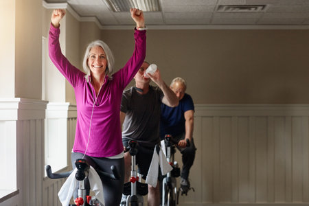 Spinning leads to winning. a group of seniors having a spinning class at the gym.の写真素材