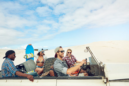 Ready for some outdoor fun in the sun. a group of young friends going on a sand boarding road trip...