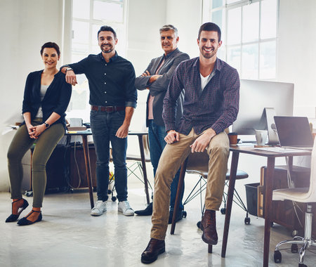 Theyre the best creative team. Portrait of a team of creative workers standing together in an office.の写真素材