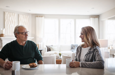 Start the day with people you love. a mature couple having coffee and a snack together during a relaxed day at home.の写真素材
