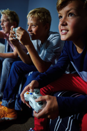 You guys ready to lose. young boys playing video games.の写真素材