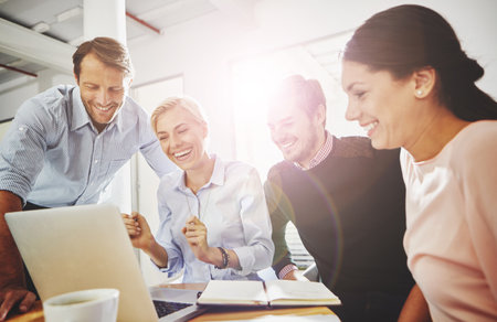 Getting it done through teamwork. a group of businesspeople in the office.の写真素材