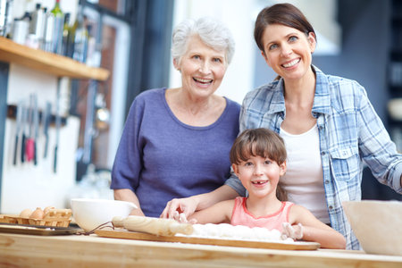 Learning her the tricks of baking. Portrait of a three generational family baking together.