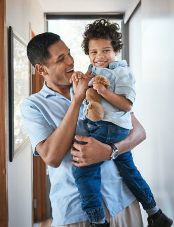 Love, father and son with a hug, smile and bonding at home, cheerful and quality time. Family, male parent and boy with happiness, kid and child in the living room, joyful and embrace with affectionの写真素材