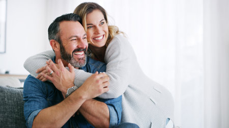 I just want to remind you that I love you. an affectionate couple relaxing together at home.の写真素材