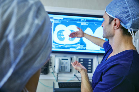 Lets just get in there...a team of surgeons discussing a patients medical scans.の写真素材