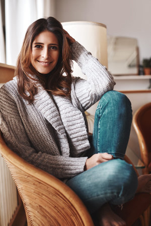 Its hard not to be happy when youre this relaxed. Portrait of an attractive young woman relaxing on...