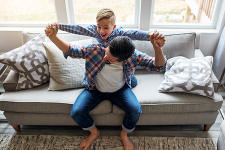 Get ready for lift off. a father and his little son bonding together at home.の写真素材