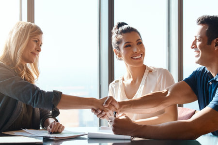 Financial advice thats worth every cent. a young couple meeting with a financial planner in a modern office.の写真素材